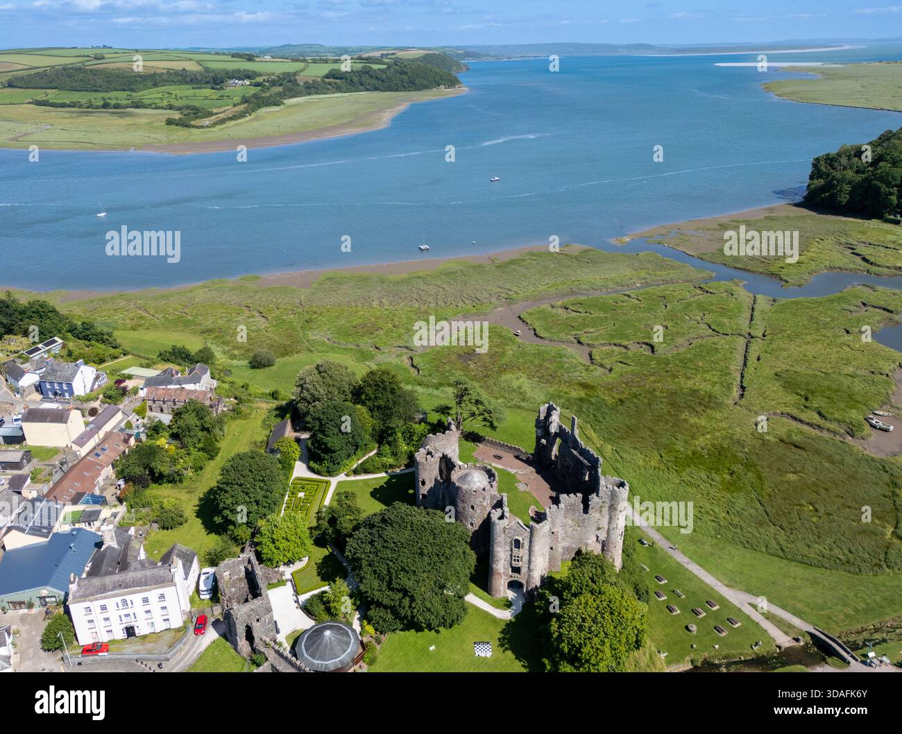 Aerial View Of Laugharne Castle Ruins Standing Proudly Amidst The Lush Aerial View Of Laugharne Castle Ruins Standing Proudly Amidst The Lush