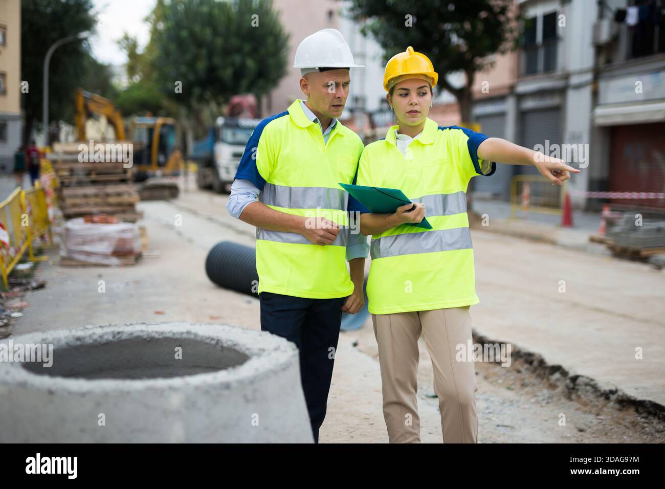 Two qualified engineers are discussing a construction plan Stock Photo