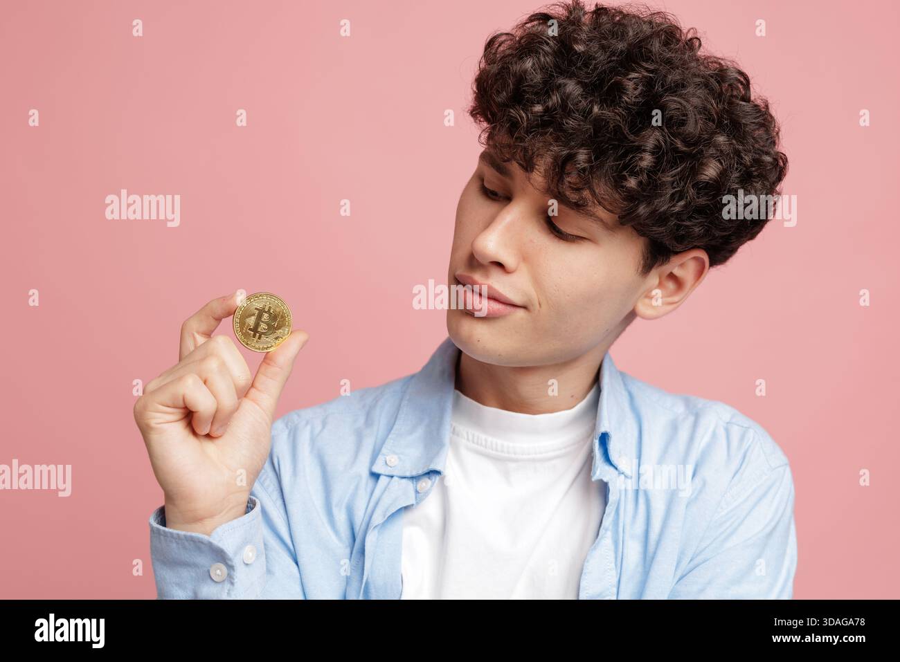 Young man looks at crypto coin in studio symbolizing cryptocurrency  investment wallet exchange market volatility and fintech future Stock Photo  - Alamy