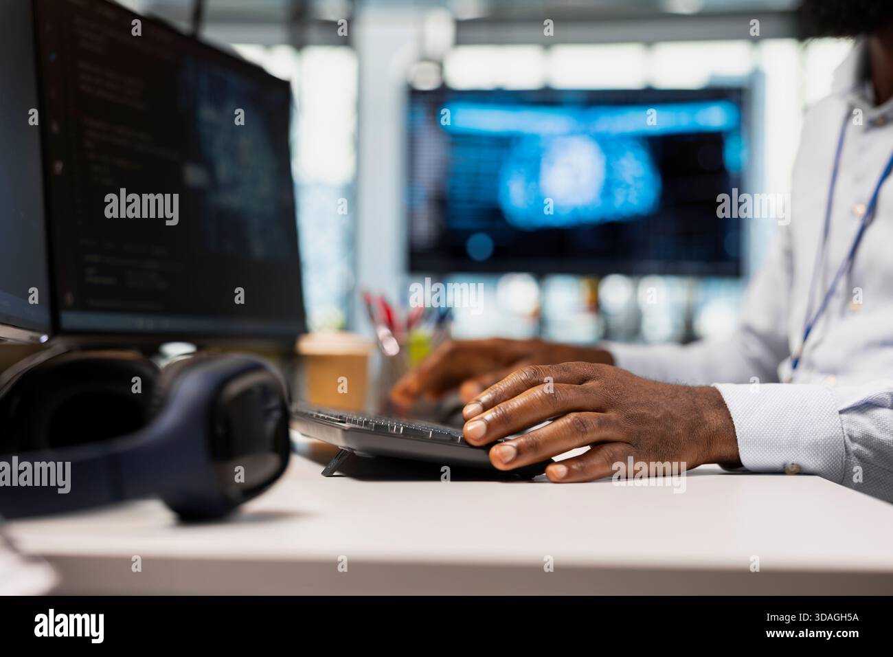 Close up of technician in office typing on keyboard, running AI automation scripts to reduce repetitive coding tasks. Worker writing code, using artificial intelligence technology on PC Stock Photo