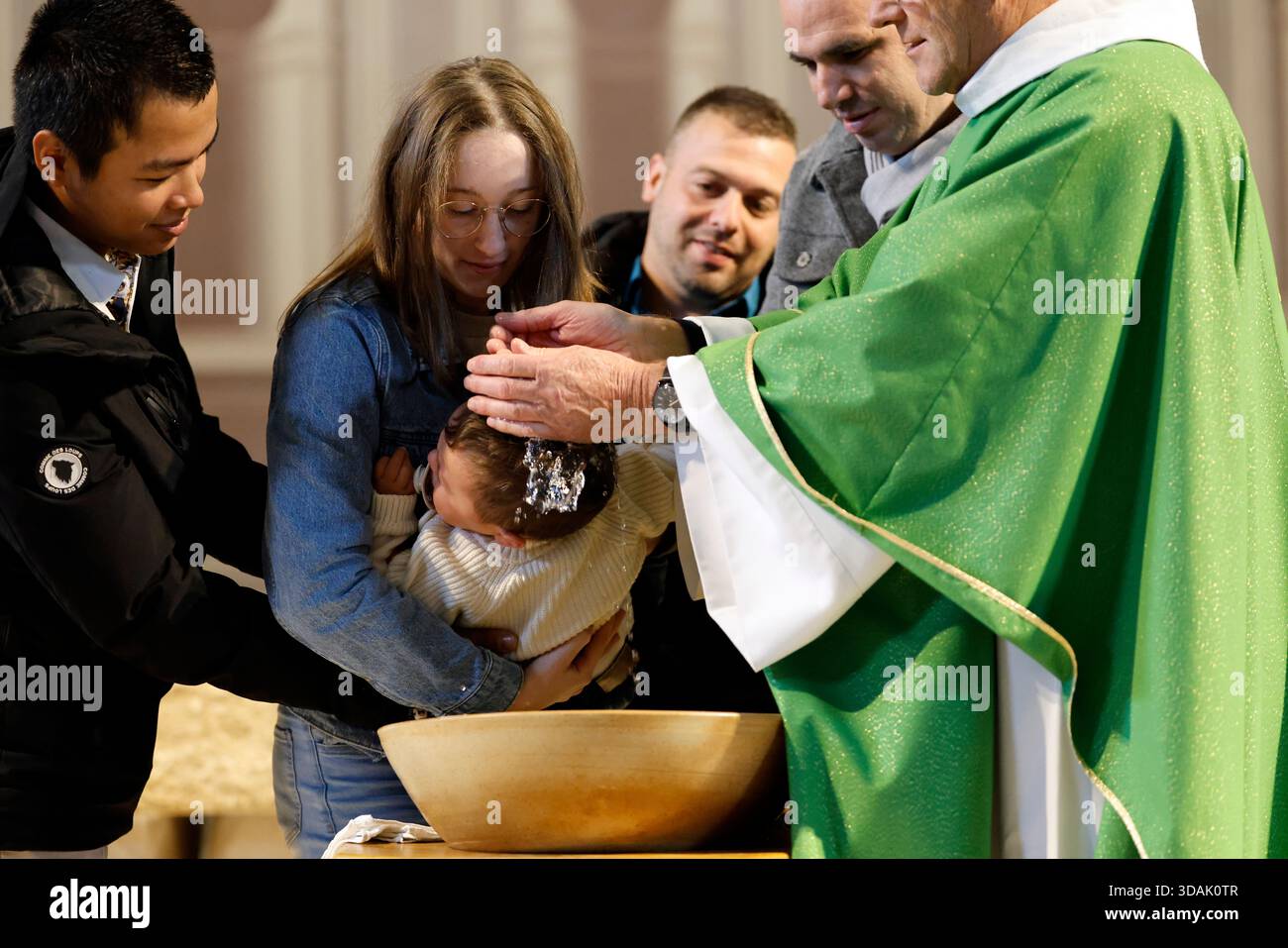 Saint Agatha Church.Baptism ceremony. The ritual of purification with ...
