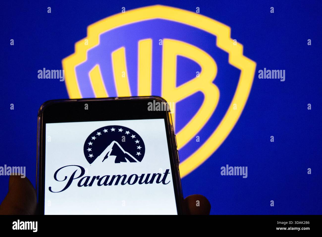 The Paramount logo appears on a mobile phone with the Warner Bros. icon ...