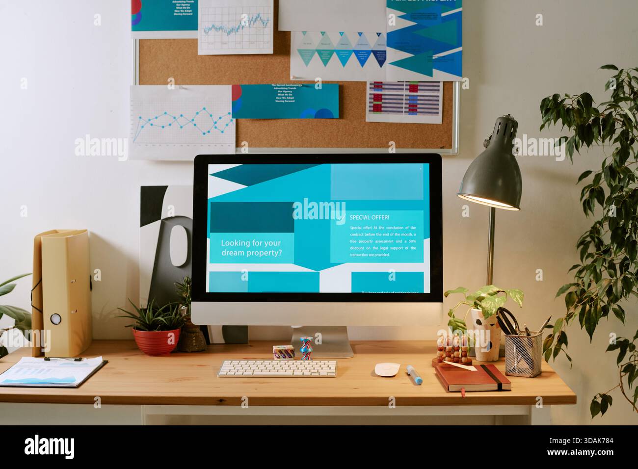 Contemporary Workspace Featuring Computer Displaying Property Search Website Stock Photo