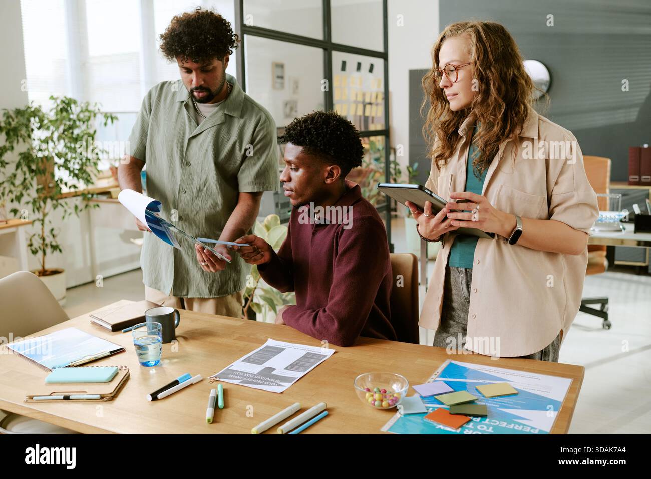 Young Multiethnic Coworkers Collaborating on Project in Modern Office Stock Photo