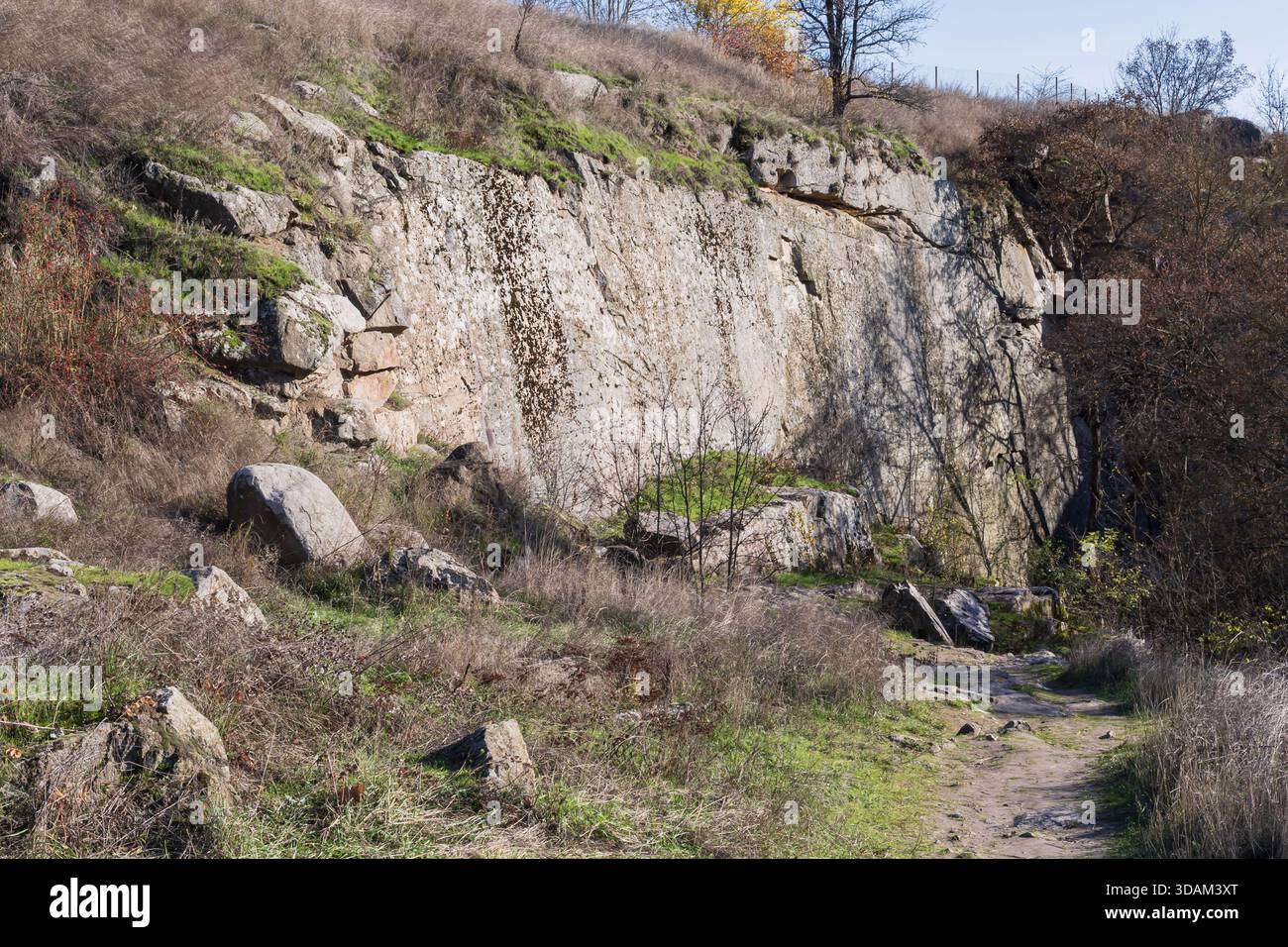 Layered rock formations and weathered stone cliffs in a natural canyon ...