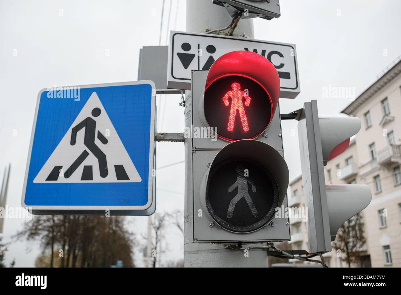 Overcast Sign Walk Signal Shows Red Light at Crosswalk With Caution Sign in Urban ...