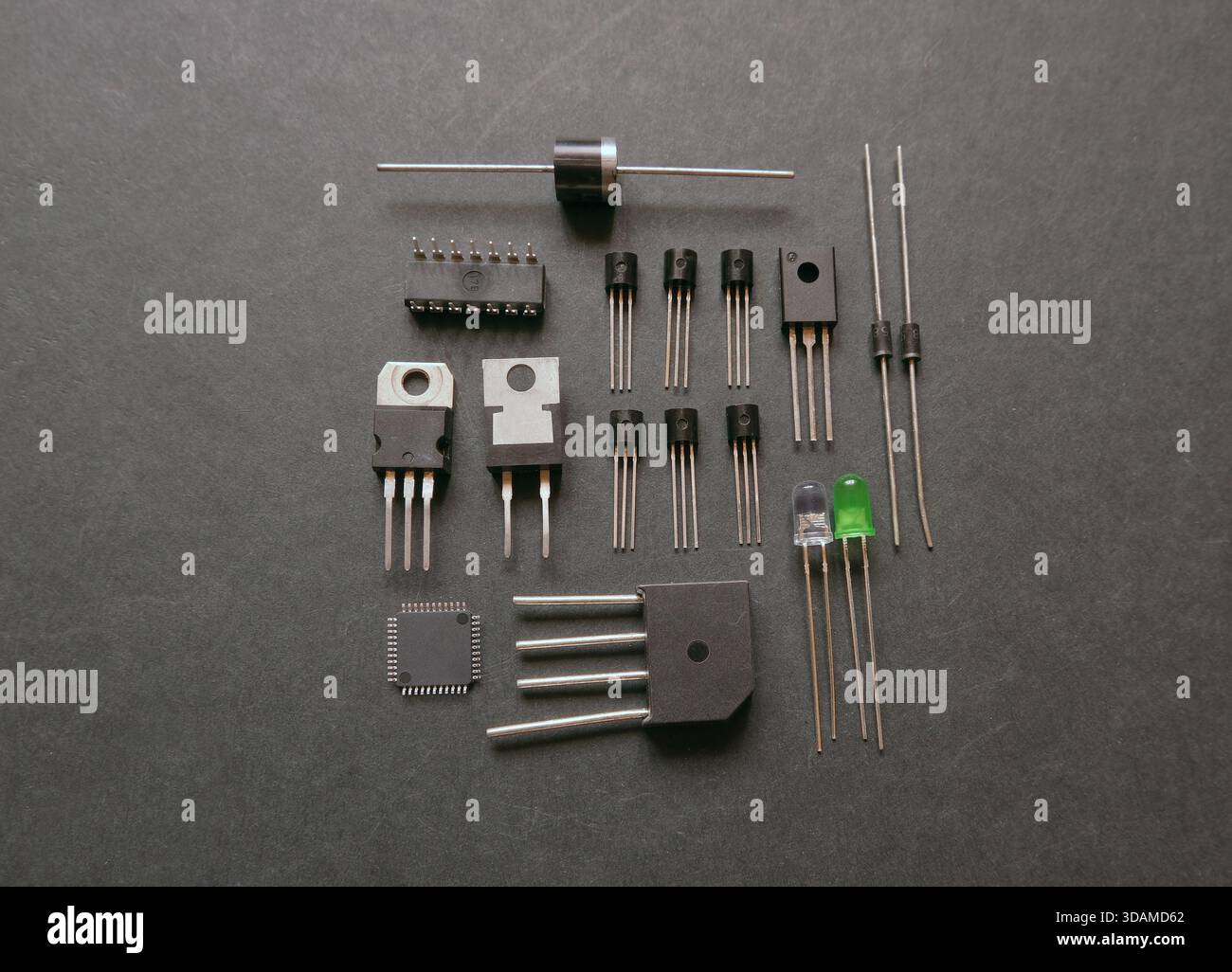 Various semiconductor components on a black. Transistors, voltage regulators, diodes. Stock Photo