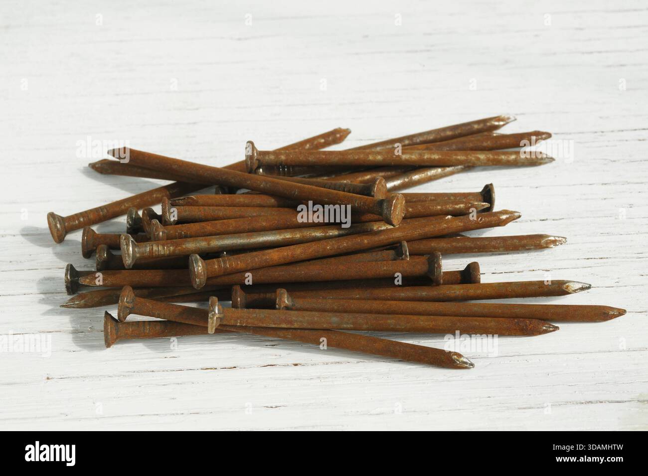 Old rusty nails on wooden background Stock Photo