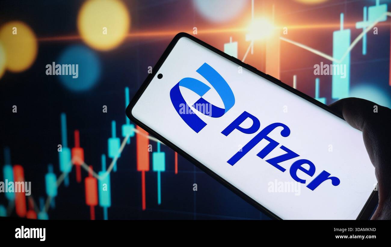 Pfizer logo displayed on smartphone screen over stock chart background, New York City, 08 December 2025 - Smartphone Captured Stock Image