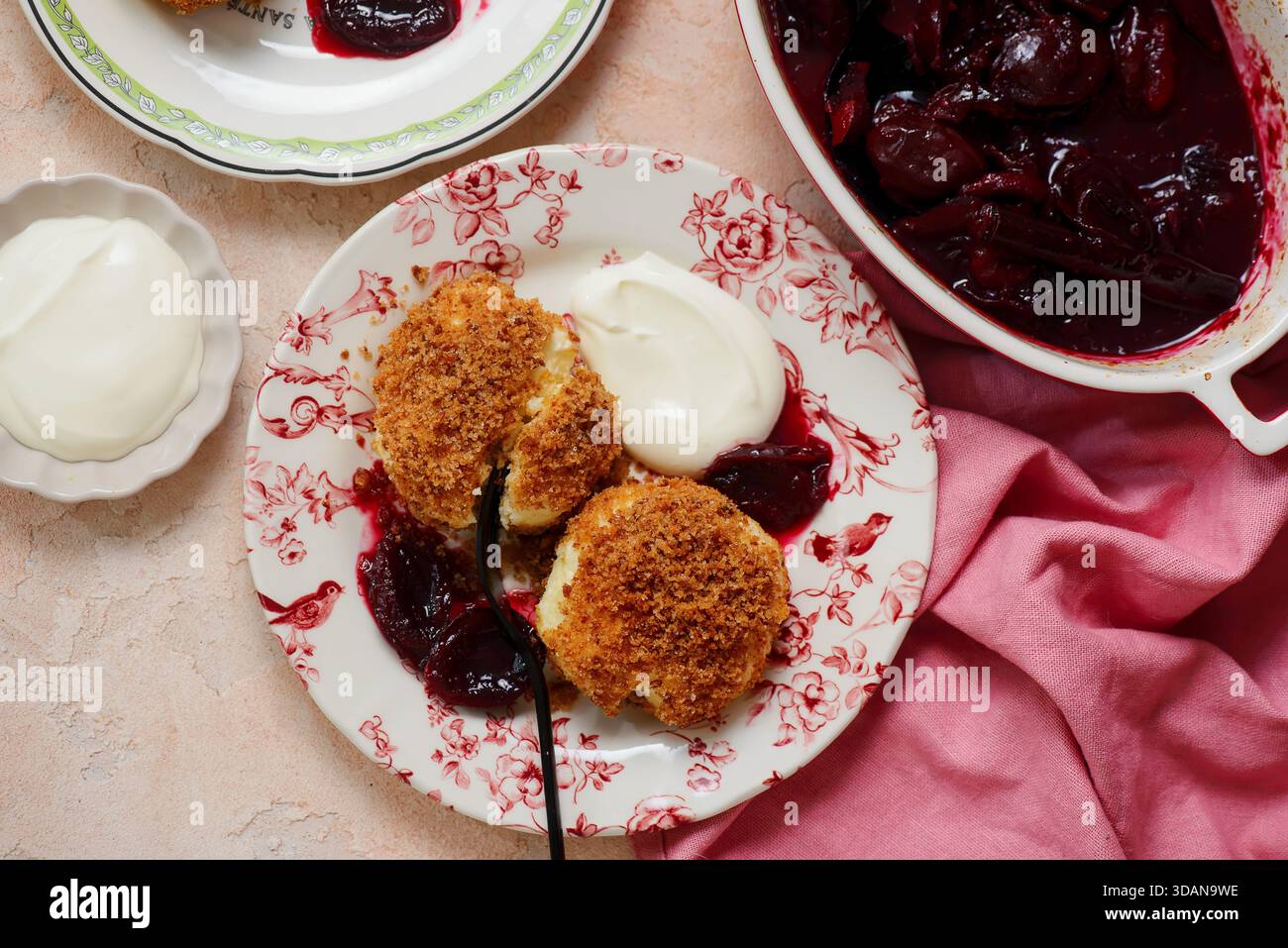 Traditional Austrian cottage cheese dumplings in breadcrumbs with plum compote and sour cream.top veiw.style hugge.selective focus Stock Photo