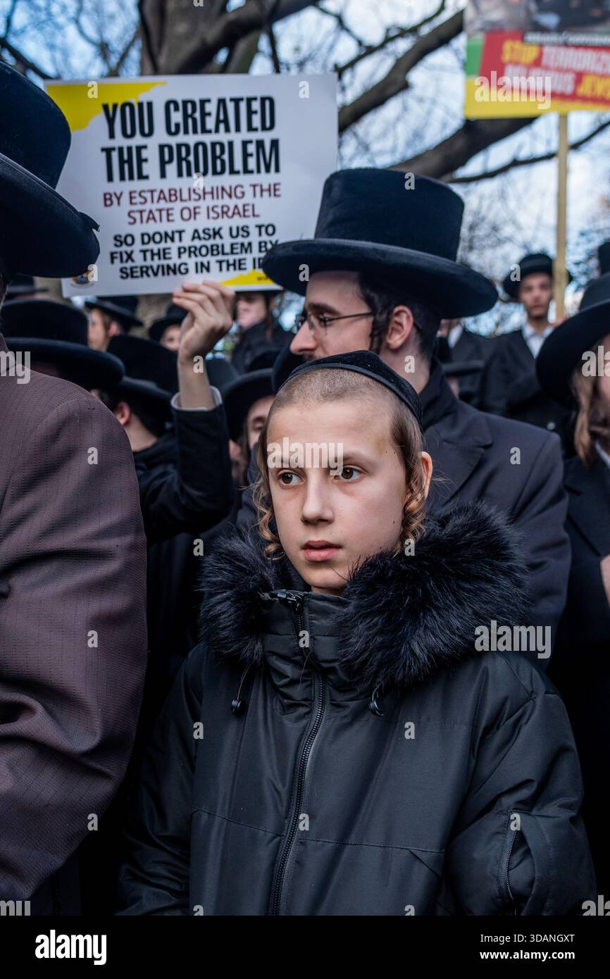 London, UK. 11th Dec, 2025. Young Orthodox Haredi Jewish boy takes part during the demonstration. Haredi Orthodox Jews gathered near the Israeli Embassy in Kensington to protest against the Israeli Army's draft conscription which threatens their religious and pacifist lifestyle centered on Torah study. Credit: SOPA Images Limited/Alamy Live News Stock Photo