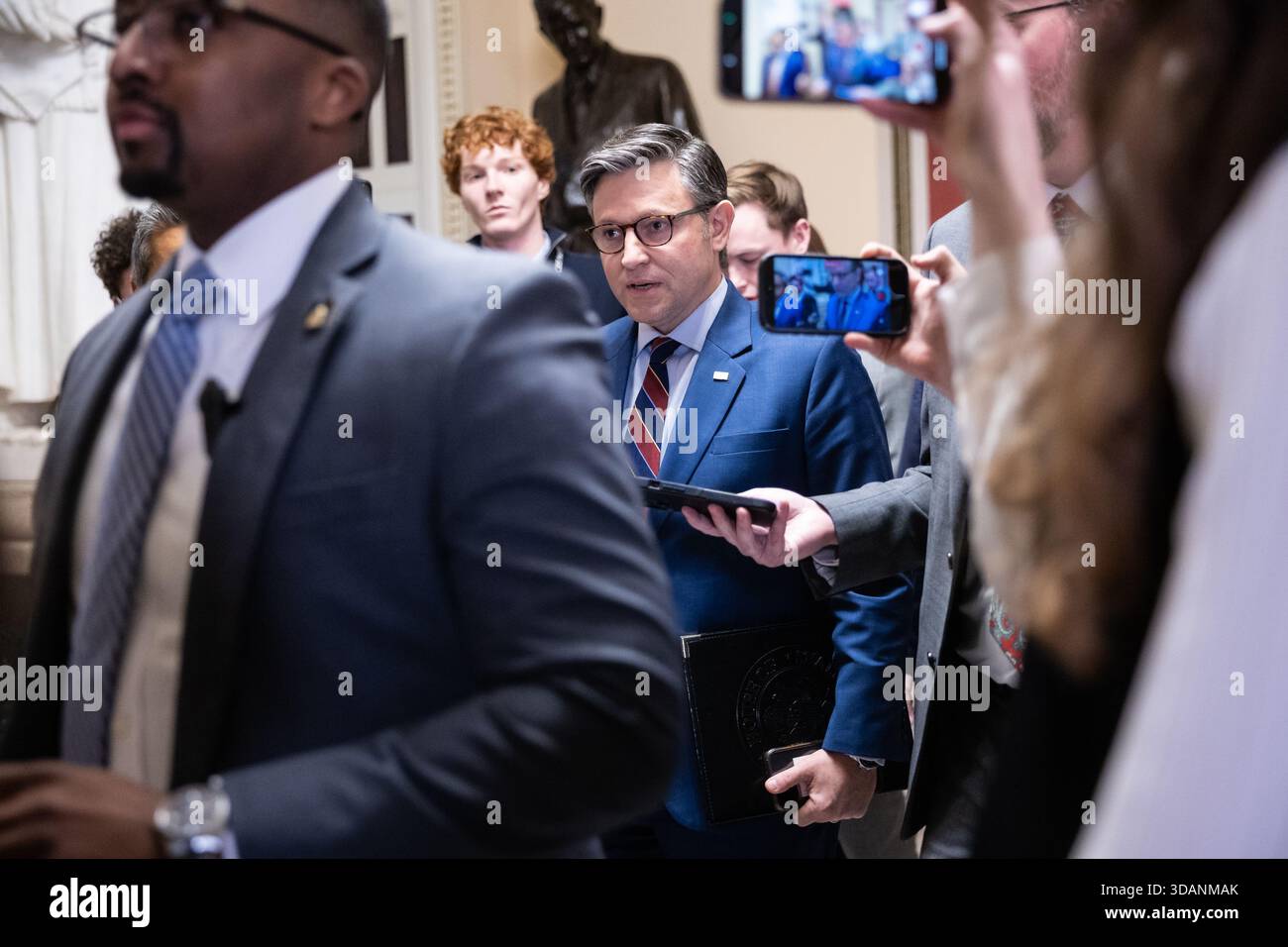House Speaker Mike Johnson (R-La.) speaks with reporters as he walks to ...
