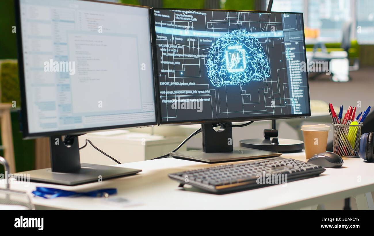 Advanced AI algorithms running on computer monitors in empty startup workspace deploying machine learning models. Artificial intelligence coding platform on PC screens in modern office Stock Photo