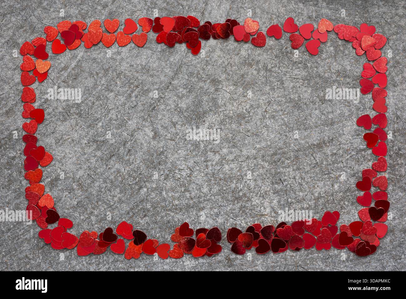 Simple frame made from many red heart confetti pieces Stock Photo