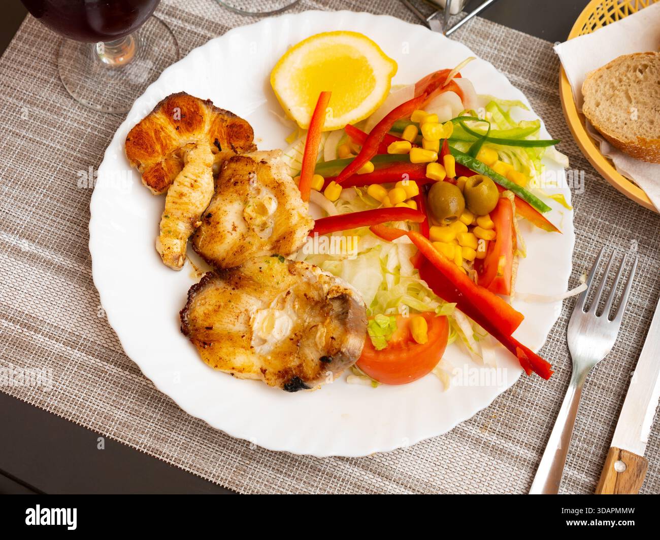 Oven baked hake with vegetable garnish Stock Photo