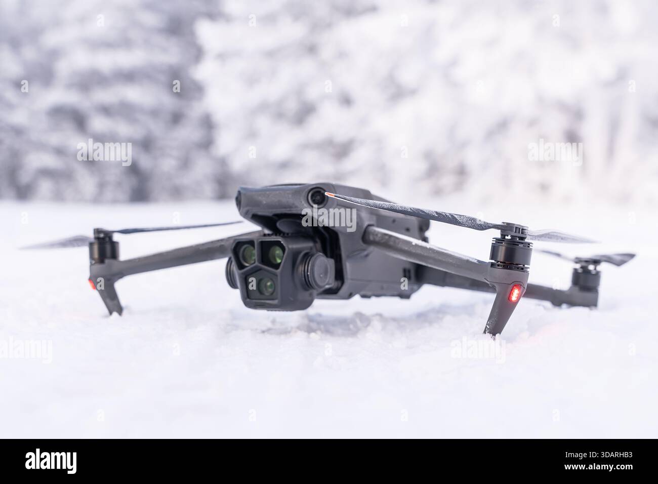 A black drone on the background of a winter forest. Winter aerial photography and aerial photography from drones while traveling. Features of Stock Photo