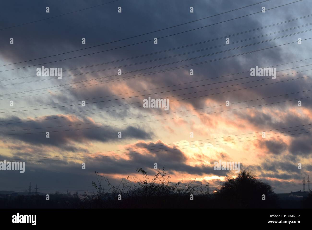 sunset light in heavy dark clouds Stock Photo