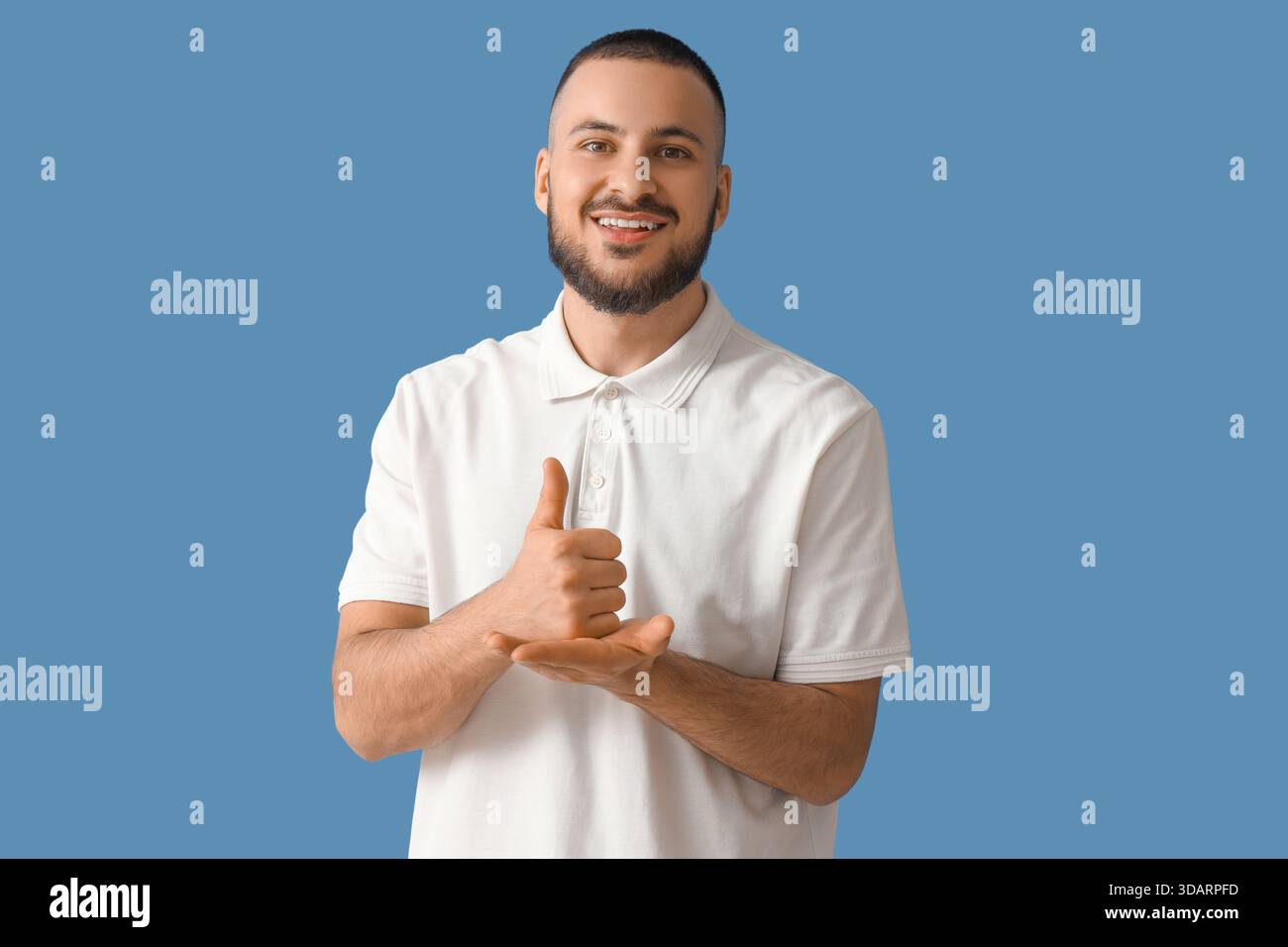 Handsome man using sign language on blue background Stock Photo