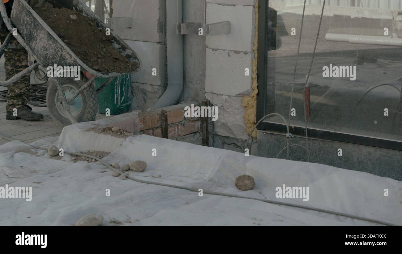Construction worker on building site using a smartphone to communicate Stock Photo