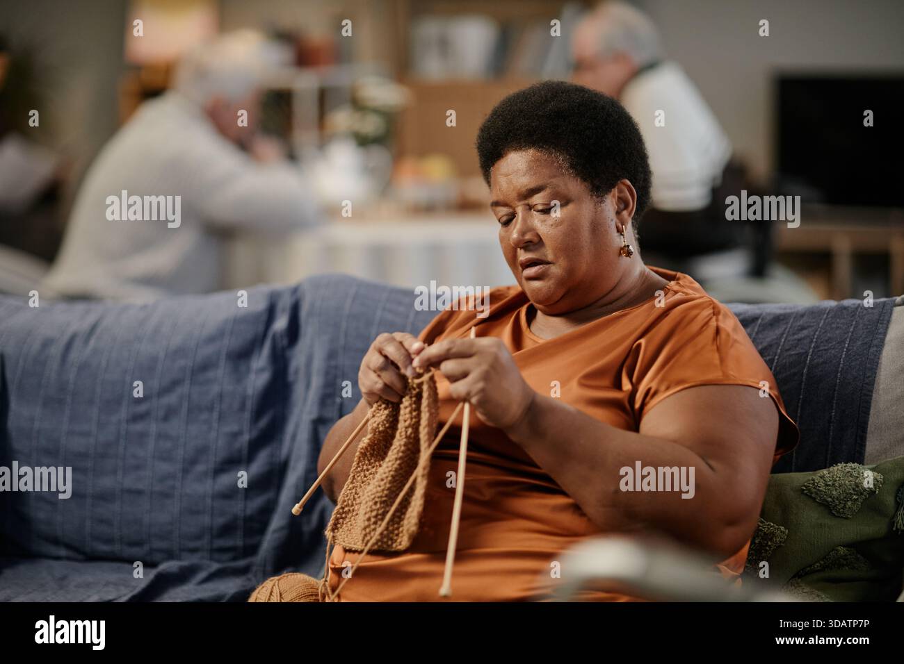Senior Black Woman Knitting While Sitting on Sofa in Nursing Home ...