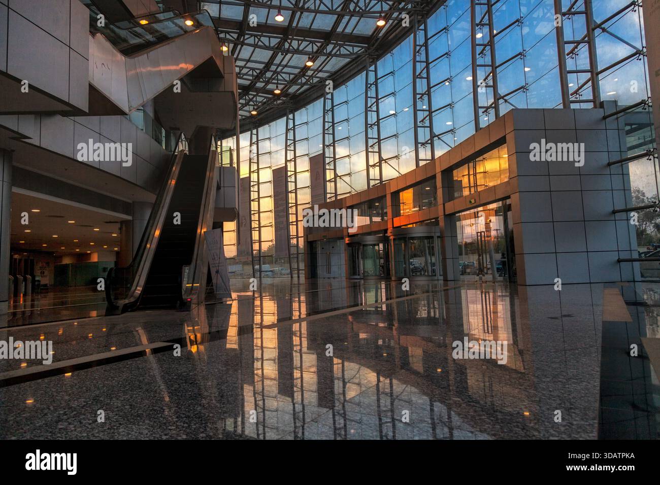 View of an escalator inside a modern building with glass walls