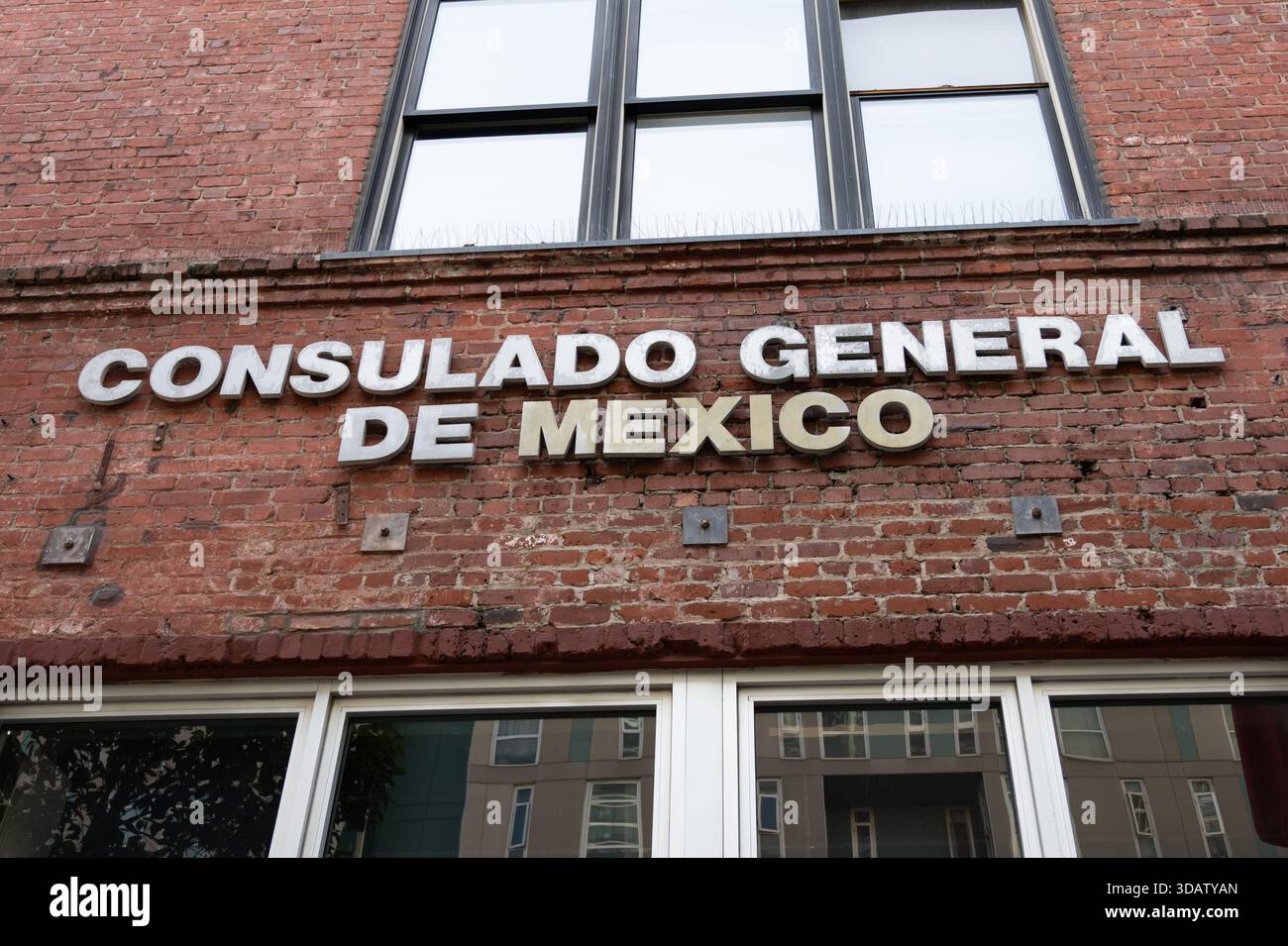 Exterior brick facade with sign for Consulado General de Mexico ...
