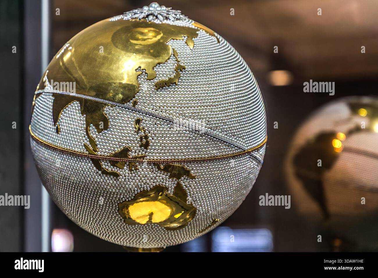 Exhibit at the Mikimoto Museum: a globe adorned with cultured pearls. The cultured pearl, originating from Mie Prefecture in Japan, conquered the world. It commemorates the achievement of producing the first successful cultured pearl in 1893, thereby honouring the founding of the company and the entire pearl culture on the island. Toba, Mie, Japan Stock Photo