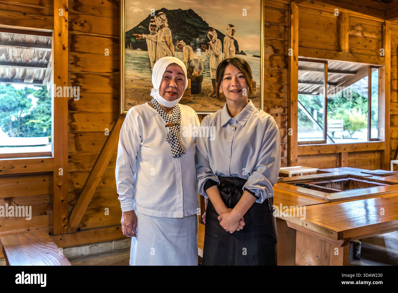 Ama diver Kimiyo Hayashi stands next to a manager of Satoumian Ama Hut, Shima, Mie Prefecture, Japan. The Ama Hut Experience and Lunch at Satoumian Ama Hut is run entirely by women. Stock Photo