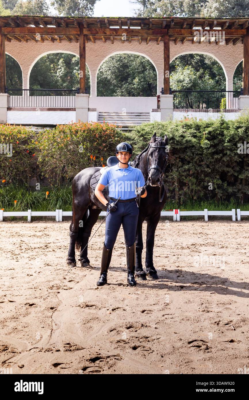 Sunny Rider A confident horse rider in equestrian attire poses with a majestic ...