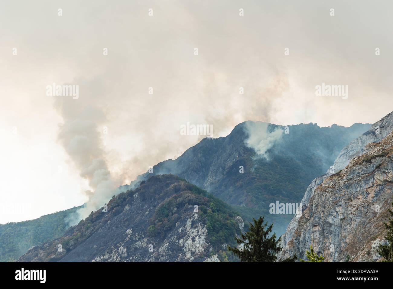 Smoke billows over mountain hi-res stock photography and images - Alamy