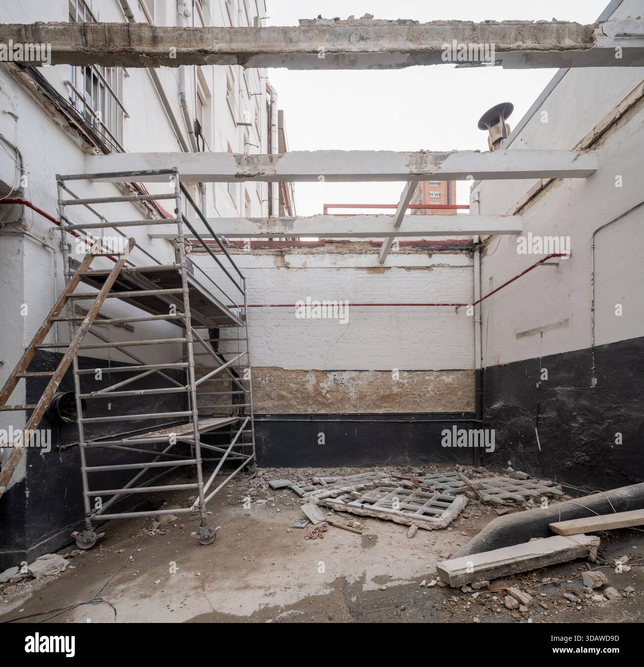 Industrial renovation site showing scaffolding and exposed beams amidst ...