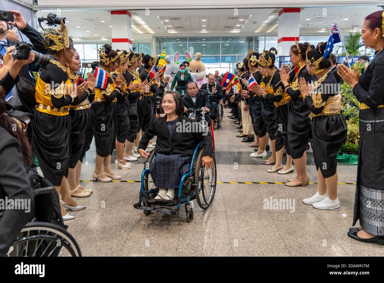 A young woman in a wheelchair is being applauded by the crowd at the ...