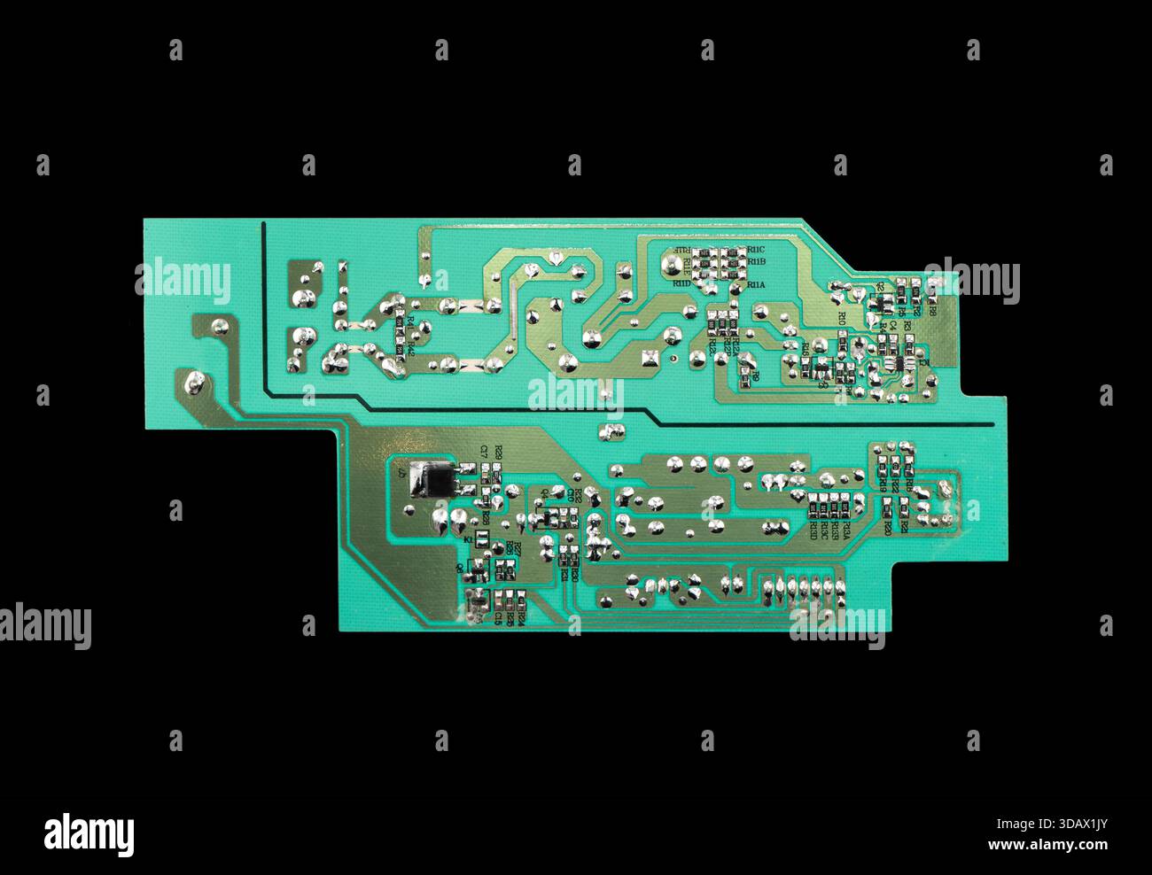 Circuit board with resistors microchips and electronic components isolated on black  background. Computer hardware technology. Stock Photo