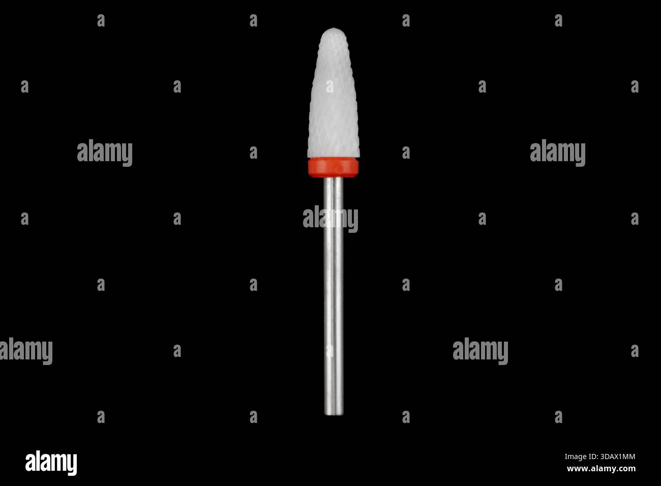 Ceramic cutter for grinding and polishing in manicure and pedicure. Drill with abrasive grain isolated on black background. Stock Photo