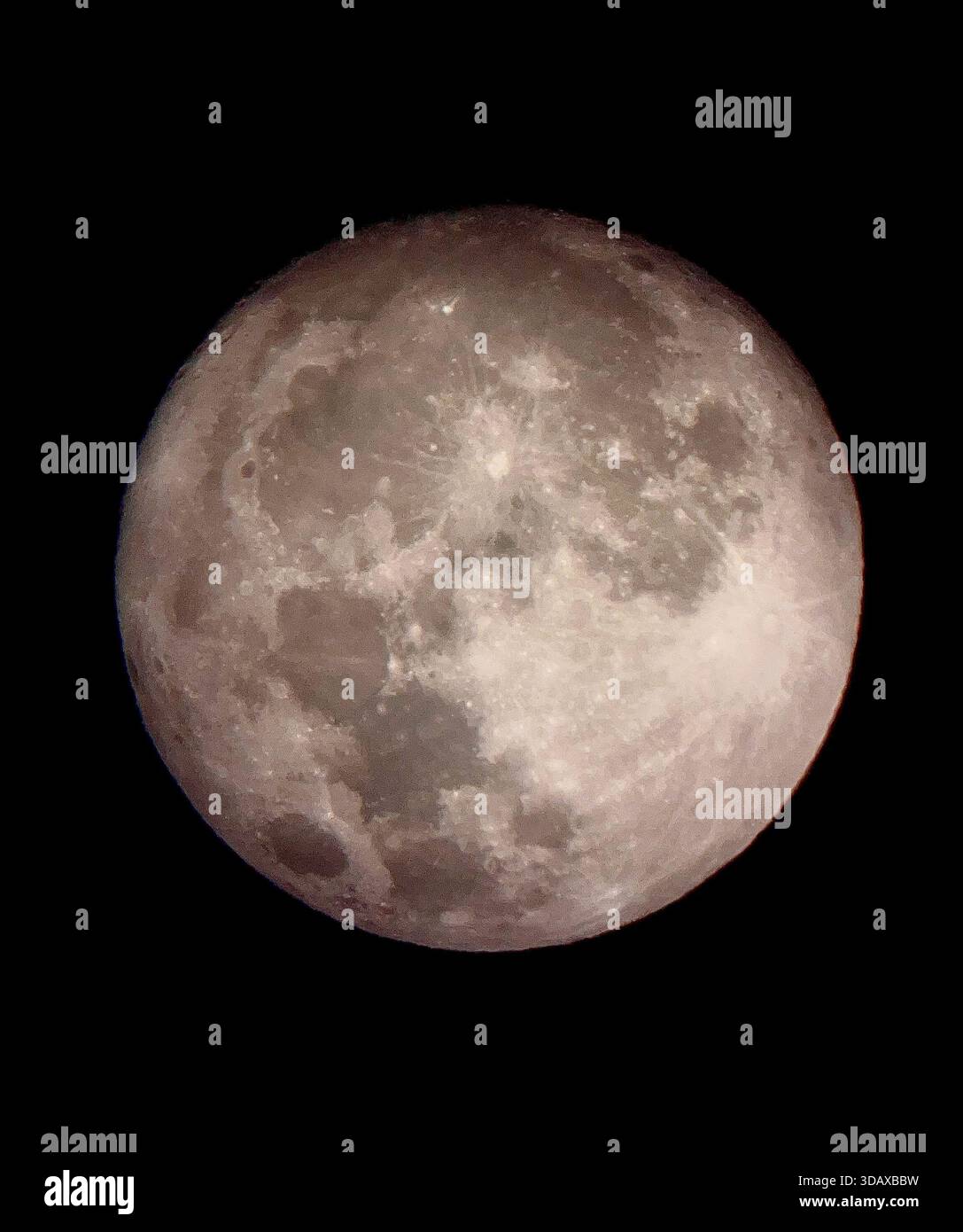 The full moon revealed in striking detail, glowing quietly in the night sky - Smartphone Captured Stock Image