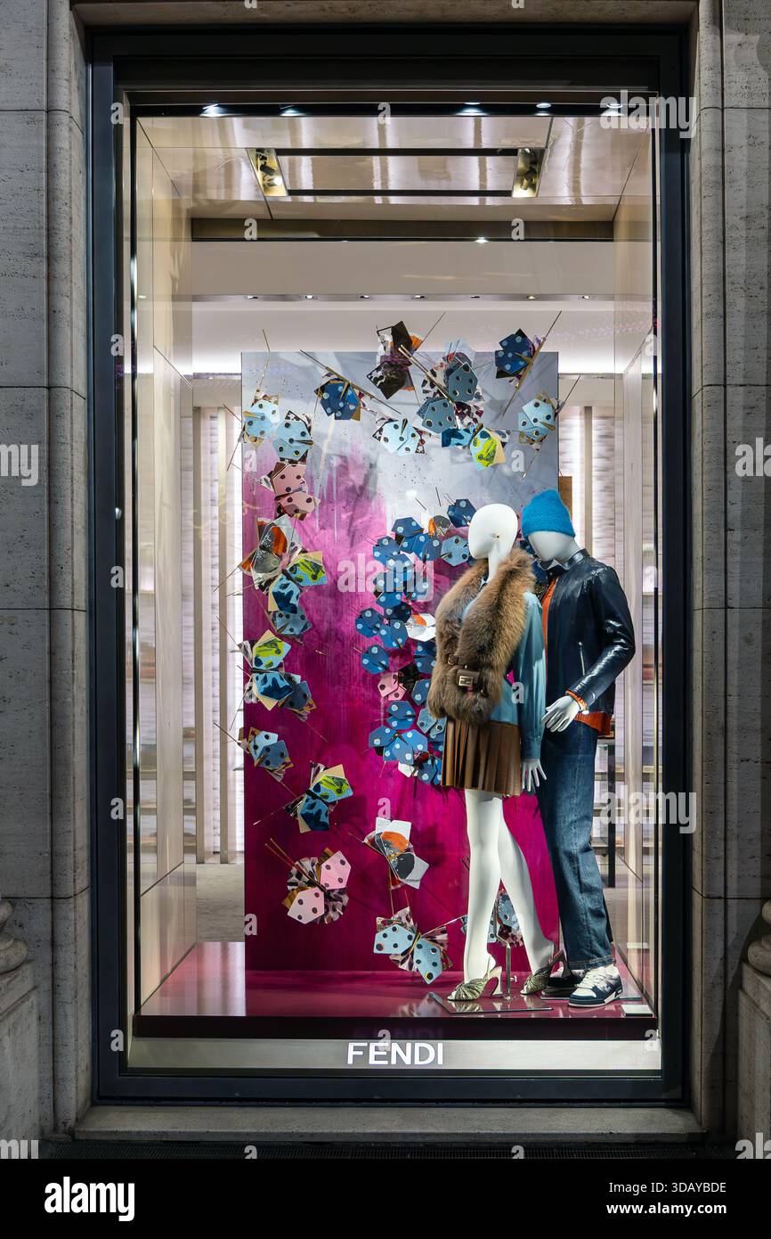 Rome, Italy - December 8, 2025: The window display with clothing and ...