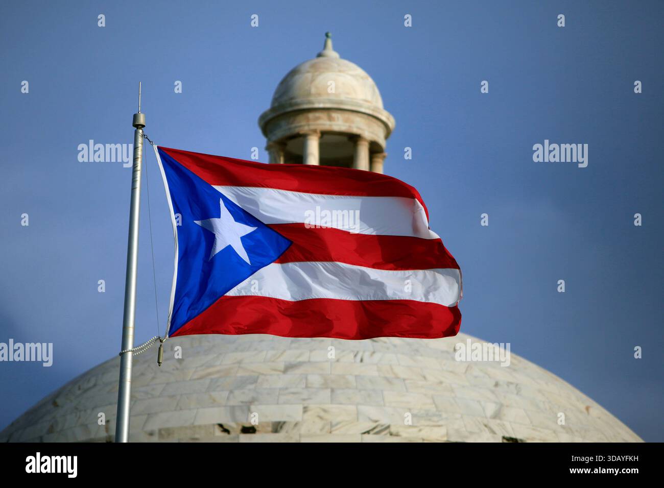 FILE - A Puerto Rican national flag flies in front of the Capitol ...