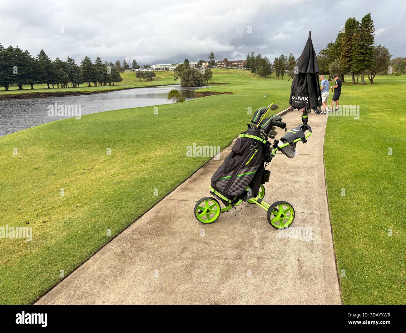 Play Golf Australia, two male golfers with their golf club bags and push buggies on Mona Vale golf course,Sydney,NSW,Australia - Smartphone Captured Stock Image