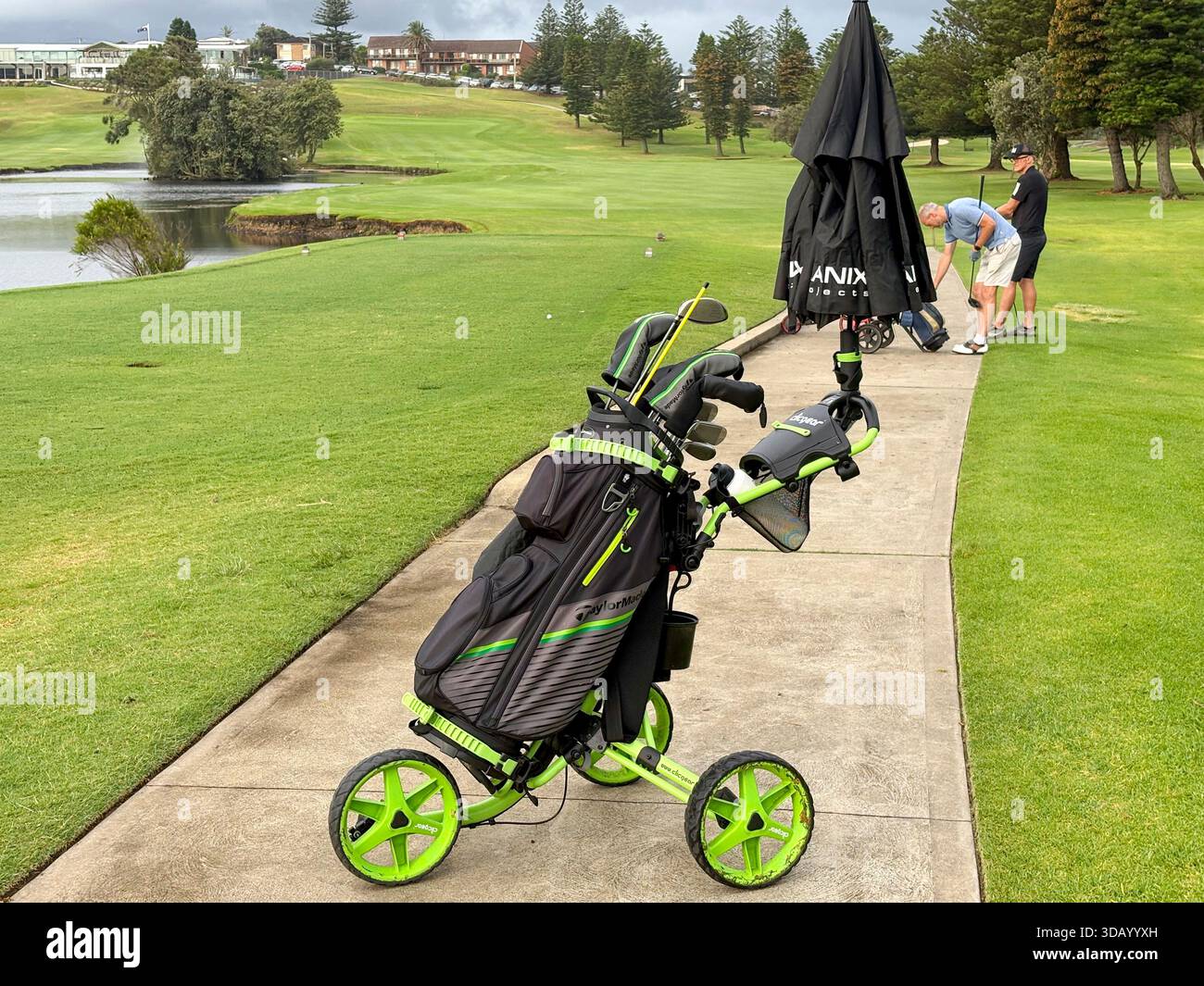 Play Golf Australia, two male golfers with their golf club bags and push buggies on Mona Vale golf course,Sydney,NSW,Australia - Smartphone Captured Stock Image