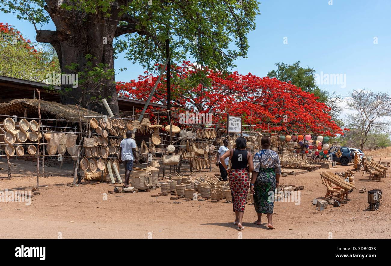 Mangoghi Monkey Island Malawi.16.11.2025.  Female tourists  looking at handmade products for tourists in the Monkey Island region of southern Malawi. - Stock Image