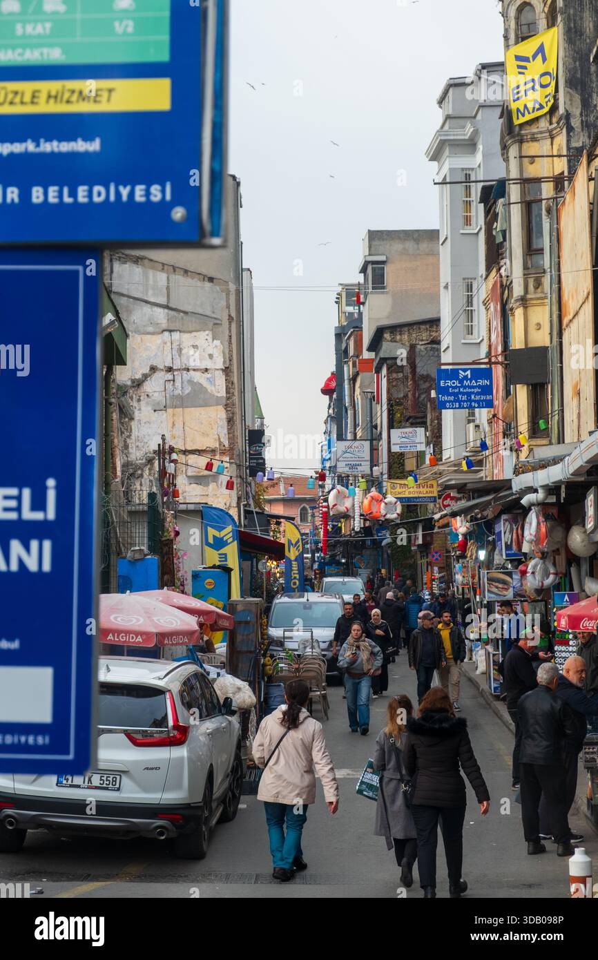 Crowded street scene with pedestrians shopping in historic Karaköy ...