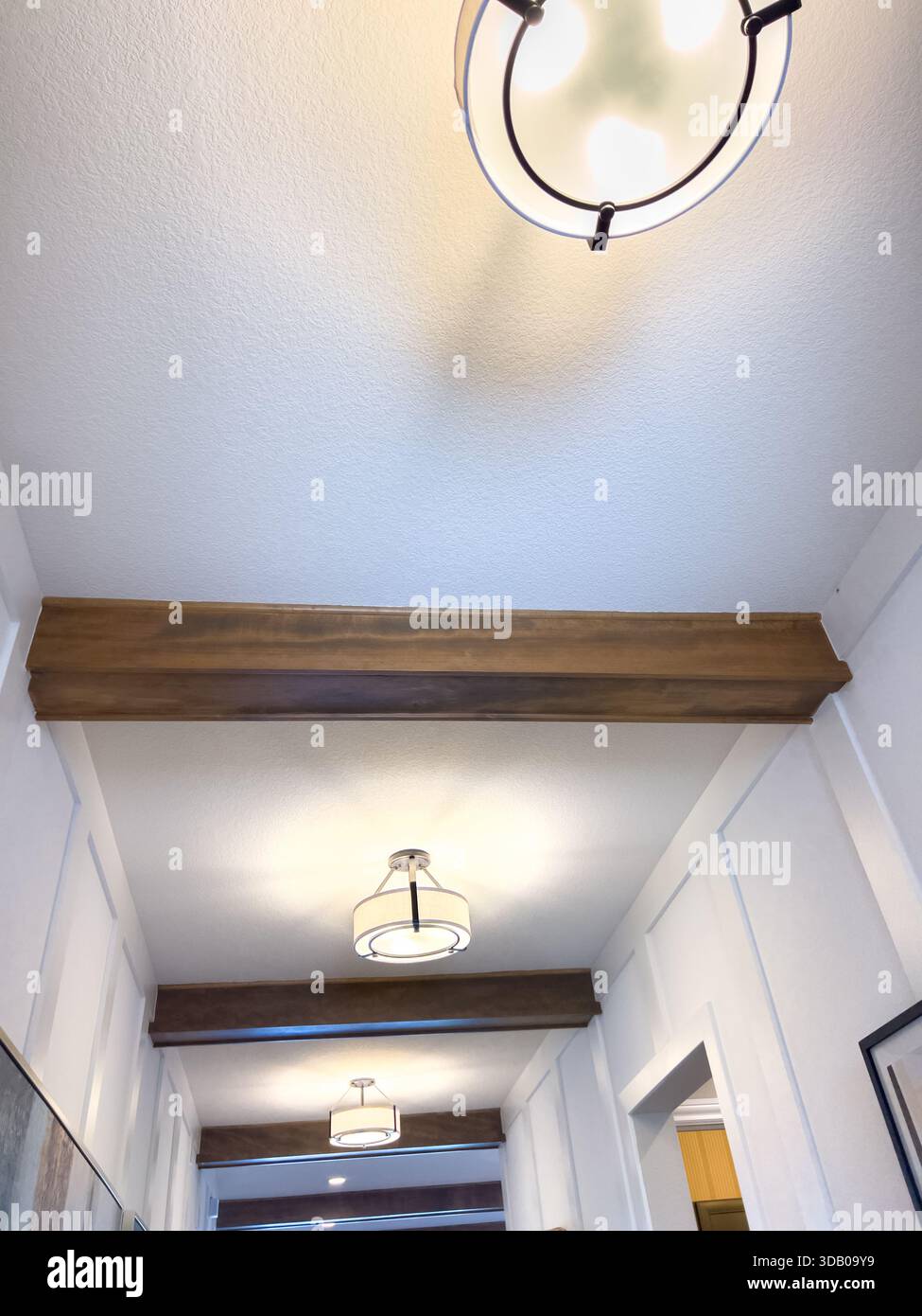 Modern hallway with wood beam and white panels Stock Photo - Alamy
