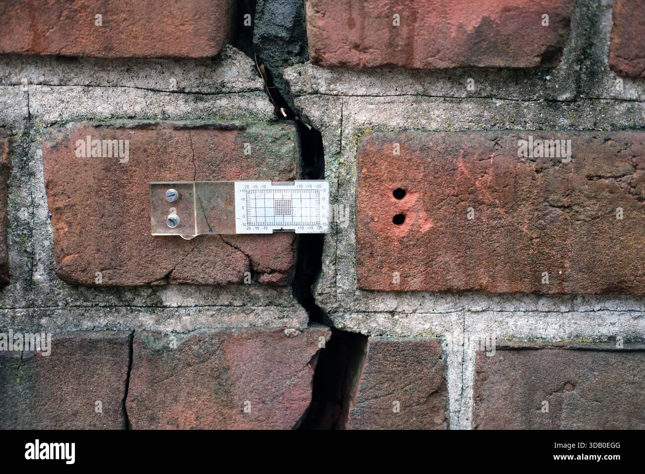 Frontal view of red and brown brick masonry wall with grey mortar ...