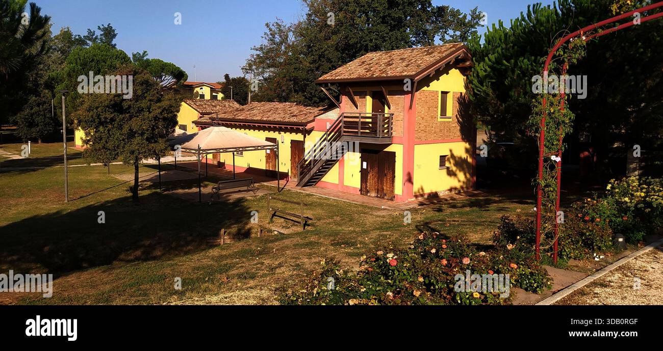 The large tree-lined park and a corner of Finotti near the famous Red House by the writer Alfredo Panzini - Stock Image