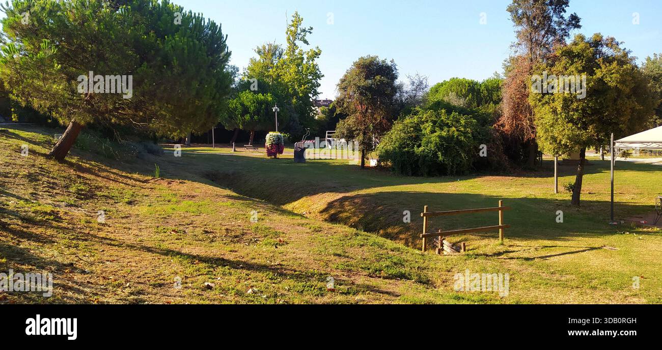 The large tree-lined park and a corner of Finotti near the famous Red House by the writer Alfredo Panzini - Stock Image
