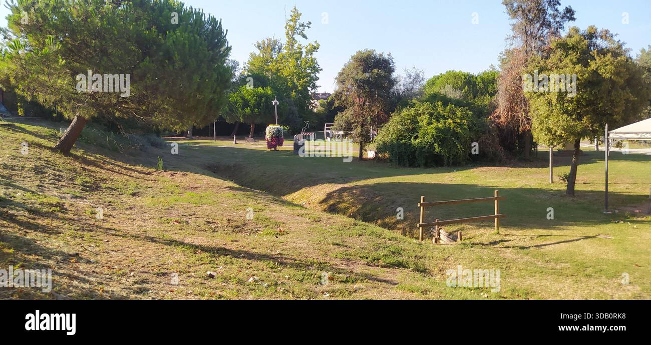 The large tree-lined park and a corner of Finotti near the famous Red House by the writer Alfredo Panzini - Stock Image