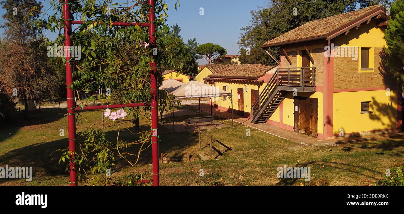 The large tree-lined park and a corner of Finotti near the famous Red House by the writer Alfredo Panzini - Stock Image