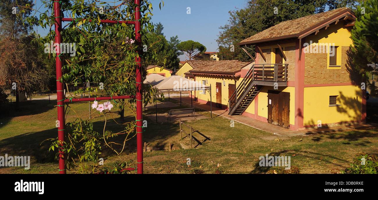The large tree-lined park and a corner of Finotti near the famous Red House by the writer Alfredo Panzini - Stock Image
