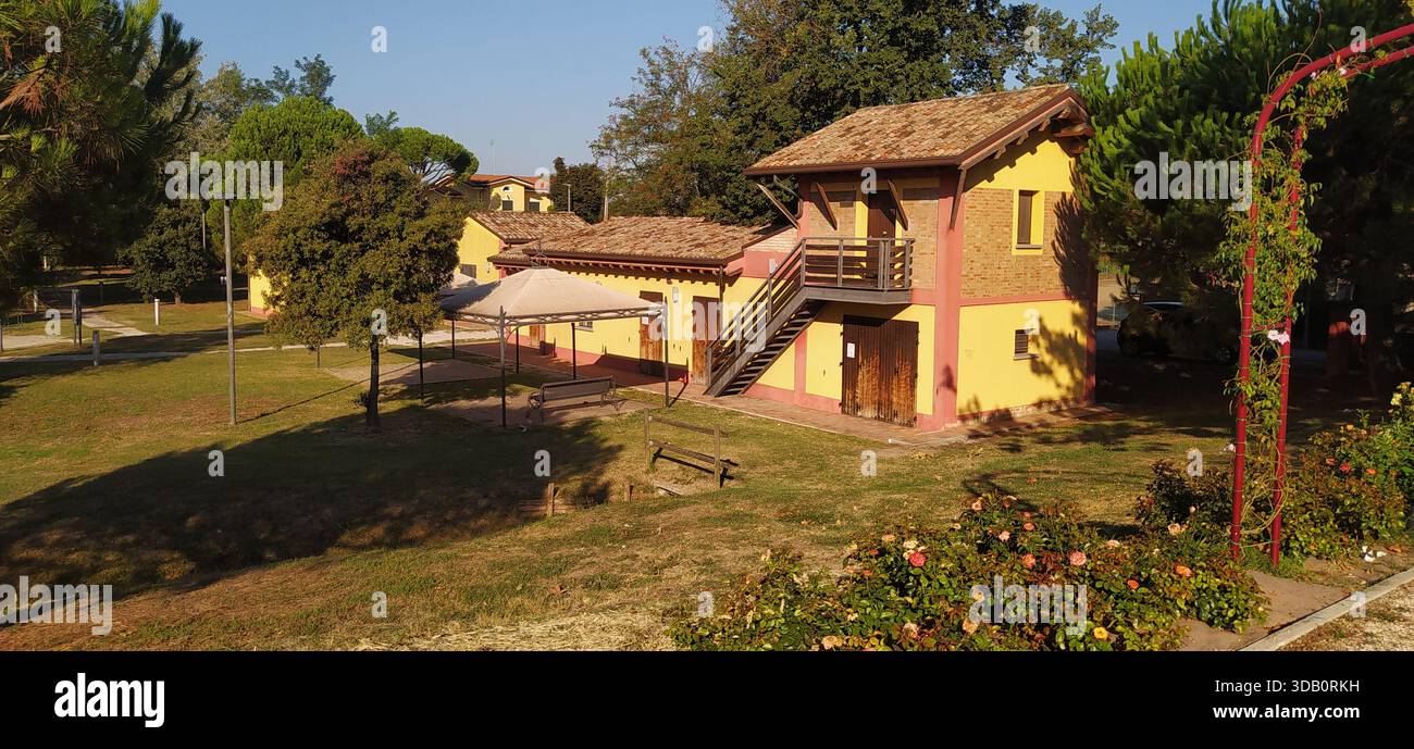 The large tree-lined park and a corner of Finotti near the famous Red House by the writer Alfredo Panzini - Stock Image