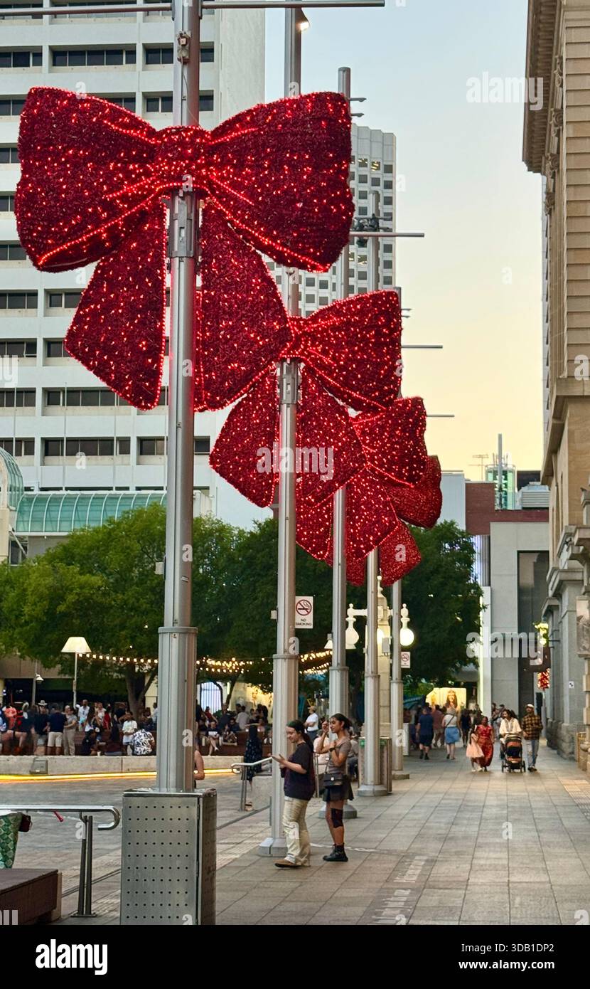 Christmas decorations large red bows on poles in Forrest Place Perth Western Australia - Smartphone Captured Stock Image